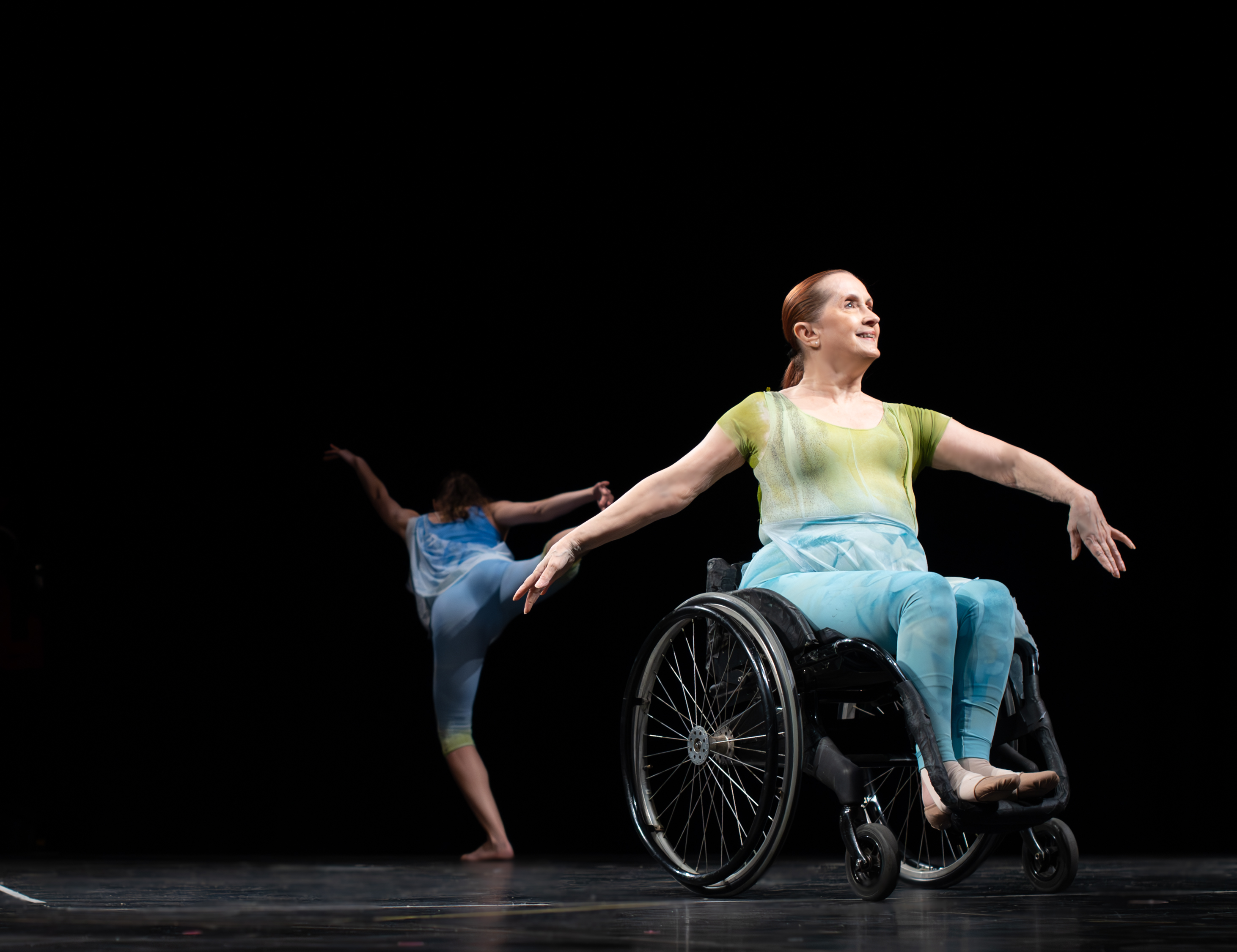 Kitty Lunn of Infinity Dance Theater performing in a wheelchair on stage